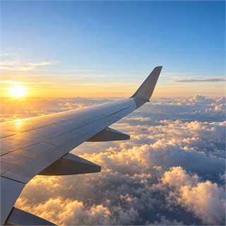 An airplane wing above the clouds